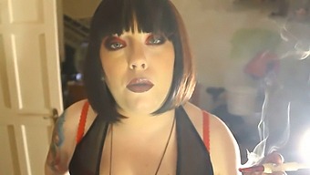 Domme Tina Smua Smokes A Cigarette In A Holder While Being Dominant